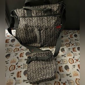 Gray Skip Hop diaper bag with matching bottle bag and pacifier holder.